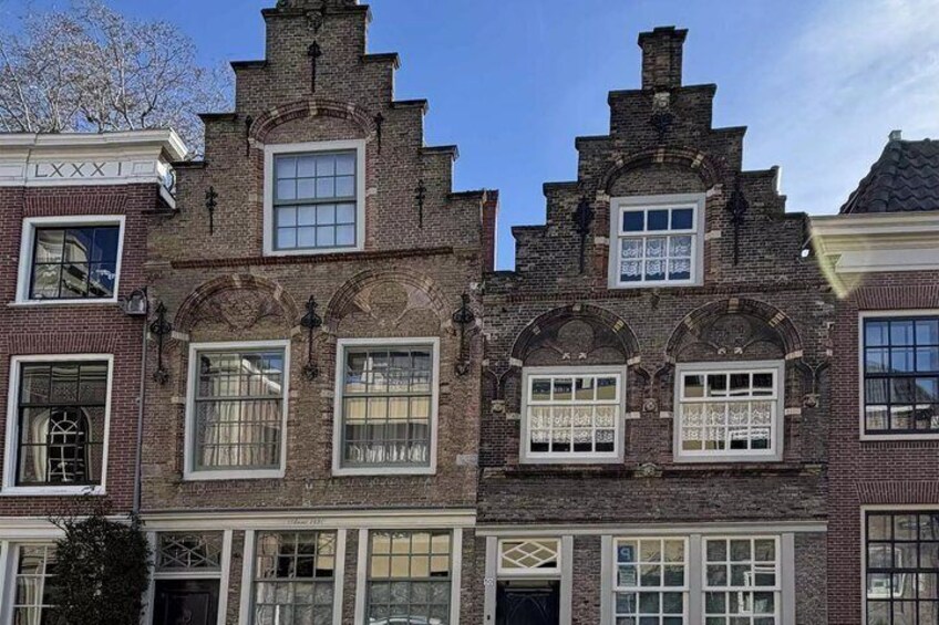 A row of traditional brick buildings with arched windows and decorative elements. 5