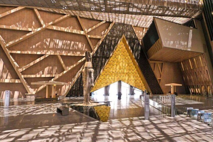 A modern architectural structure with geometric patterns and a central triangular design. 5