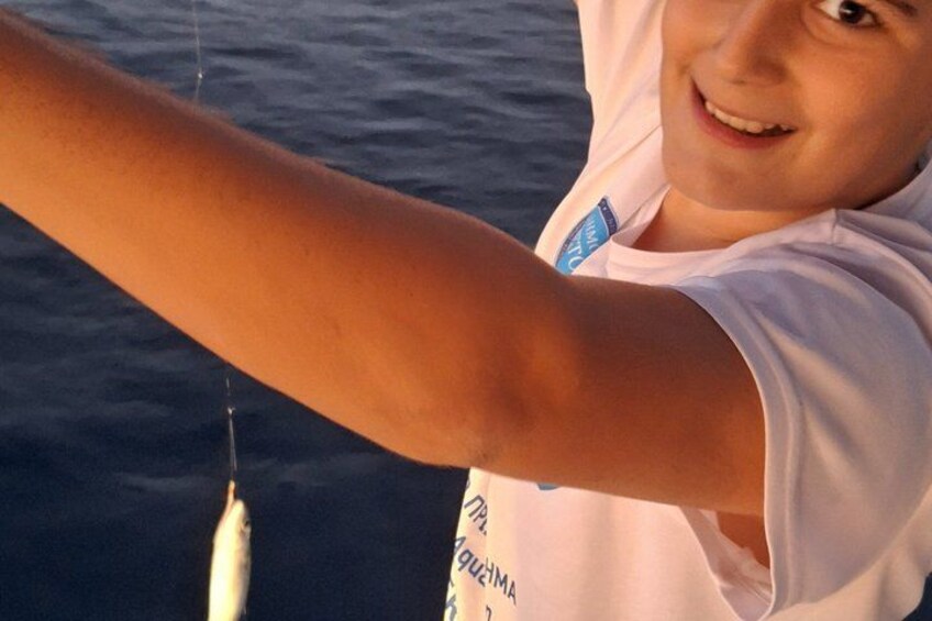 A person holding a fishing rod over water. 2