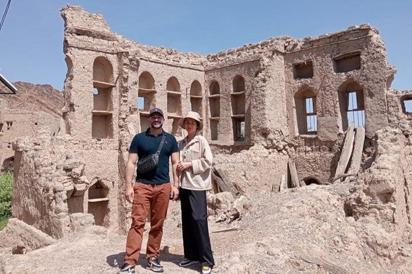 A historical building with arched windows and a collapsed structure. 5