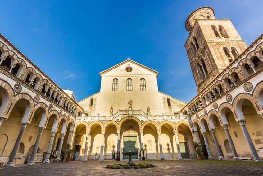A historic building with a central dome and a bell tower. 1