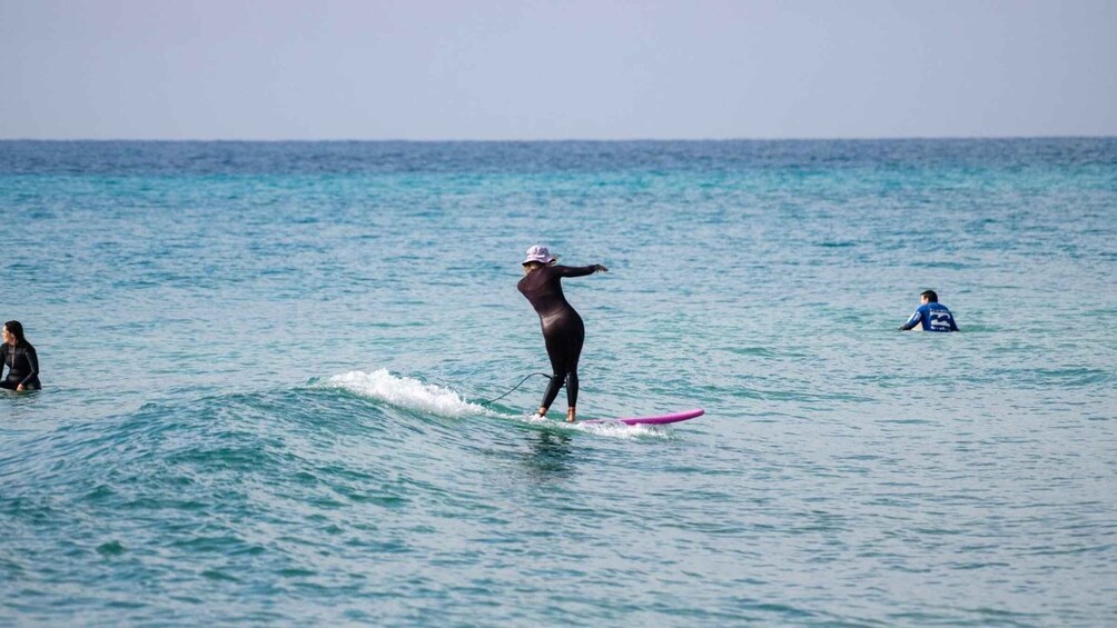 A person surfing on a wave in the ocean. 1