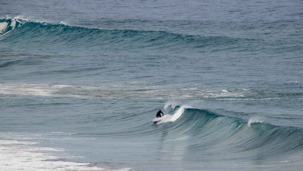 A surfer riding a wave in the ocean. 3