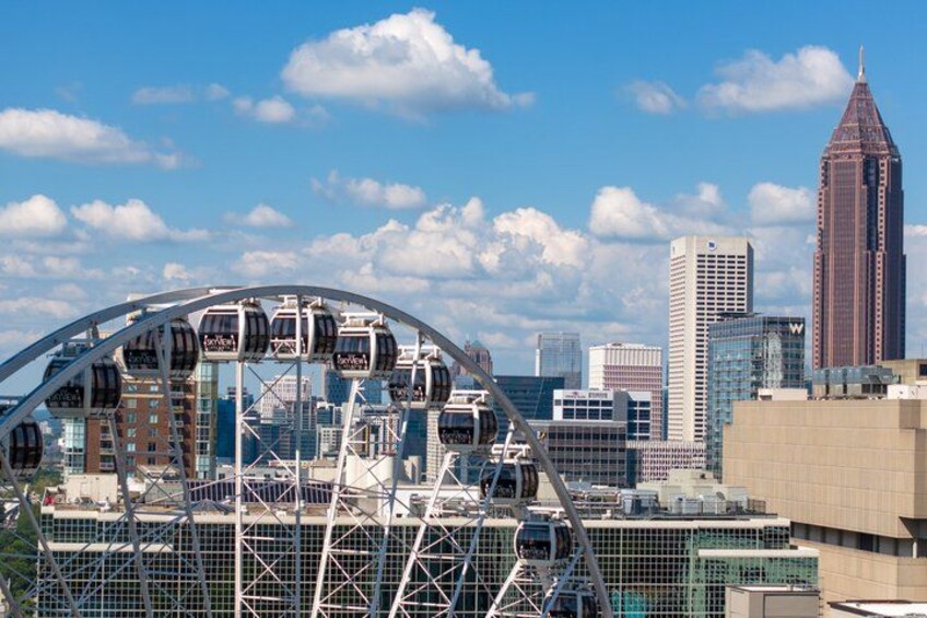 A Ferris wheel, a tall building, and a city skyline. 1
