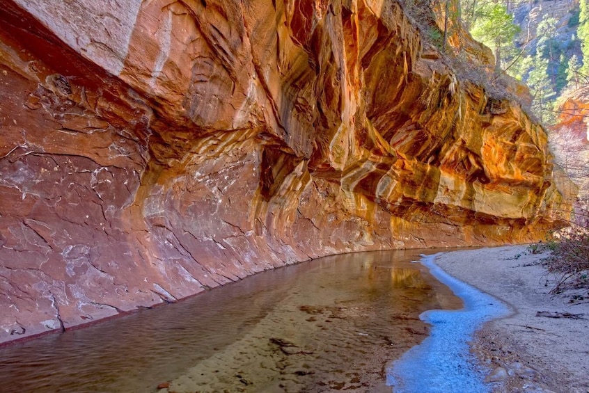 A river flowing through a canyon with colorful rock formations. 5