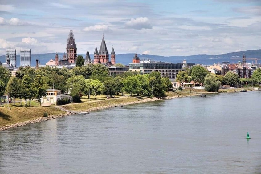 A river with a cityscape in the background, including historic buildings and modern skyscrapers. 5