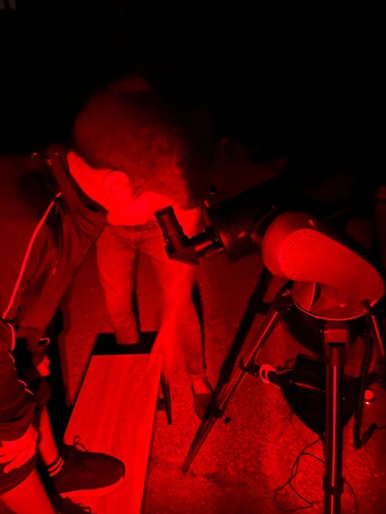 A person playing a brass instrument, likely a trumpet, with a microphone stand nearby. 2