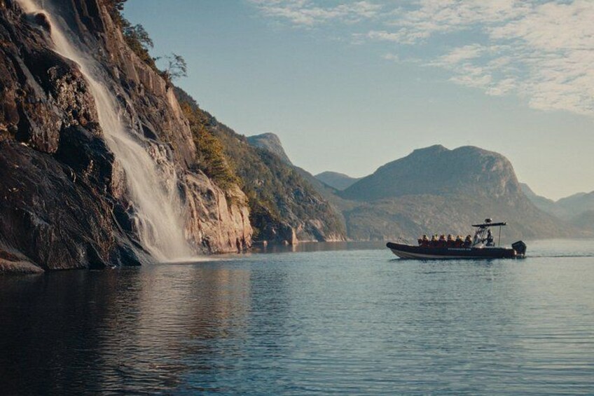 The boat driving up to a waterfall in the fjord 3