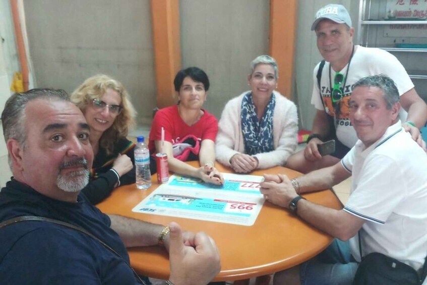 A group of people sitting around a table with documents and a water bottle. 4