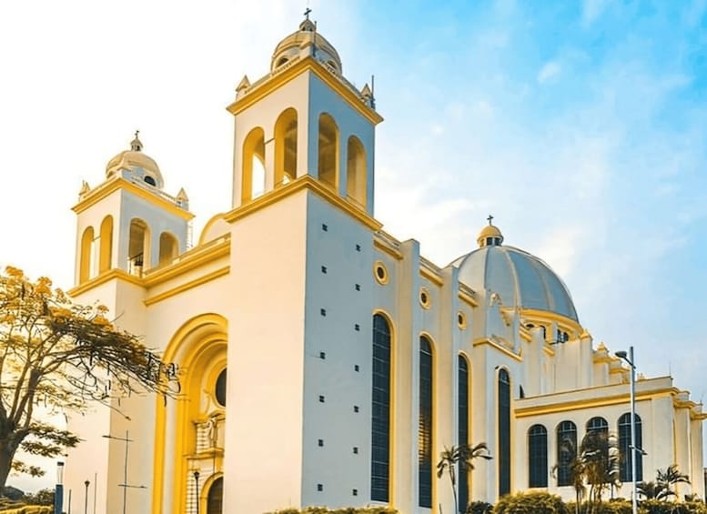A large white church with a dome and two bell towers. 1