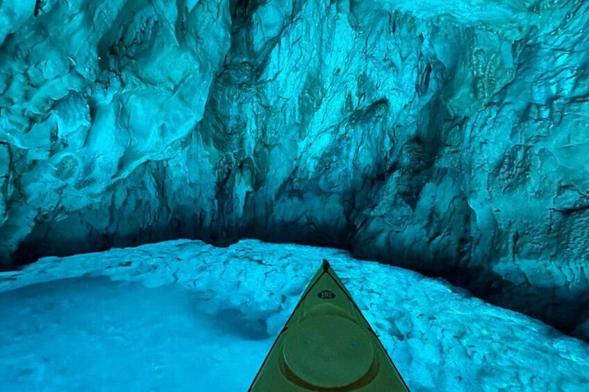 A kayak in a cave with ice formations. 2