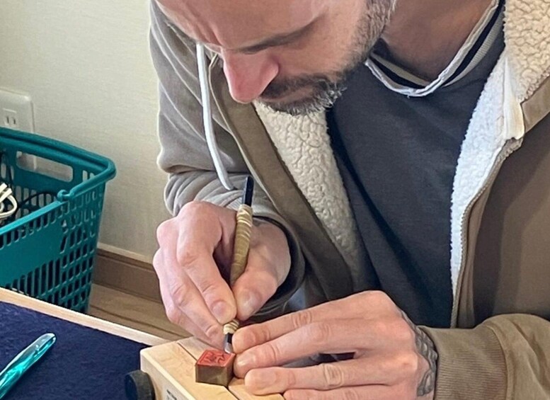 A person using a tool on a wooden object. 1