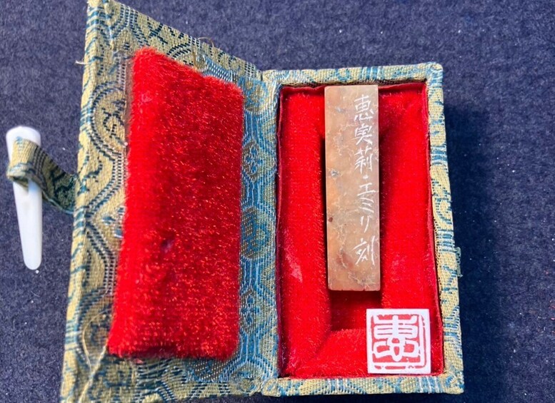 A traditional Chinese medicine set with a red cushion, a brown box, and a white object. 2