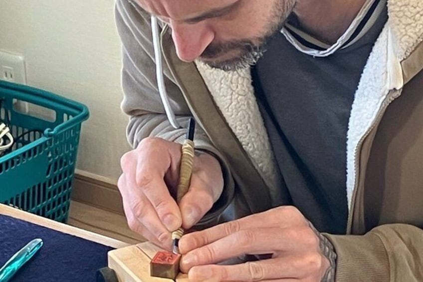 A person using a pen to write on a piece of paper. 1
