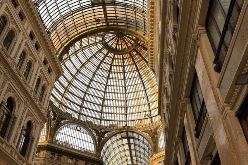 A grand architectural structure with a large glass dome and intricate stonework. 4