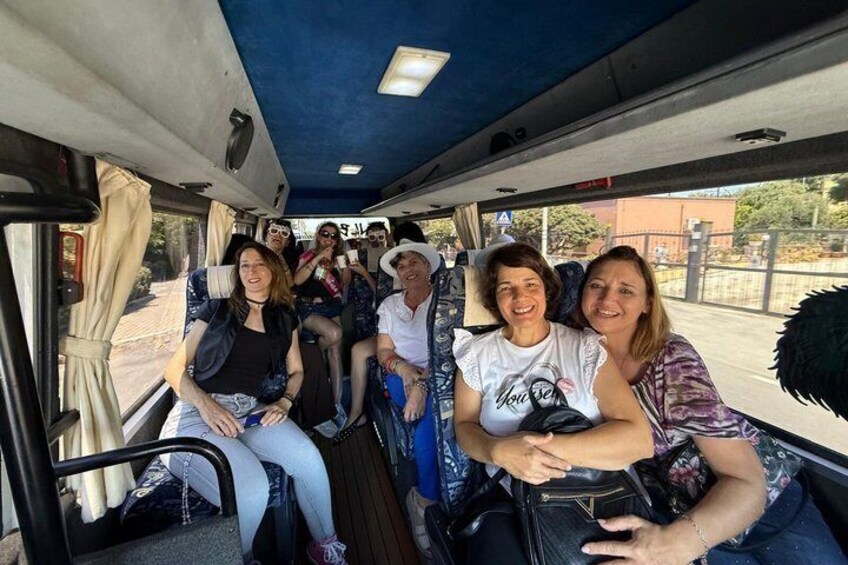 A group of people seated inside a bus. 1