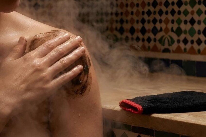 A person with a wet, possibly sunburnt, arm resting on a wooden surface. 2