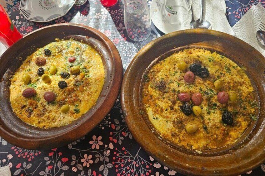 Two traditional Moroccan tagines on a table with a floral tablecloth. 4
