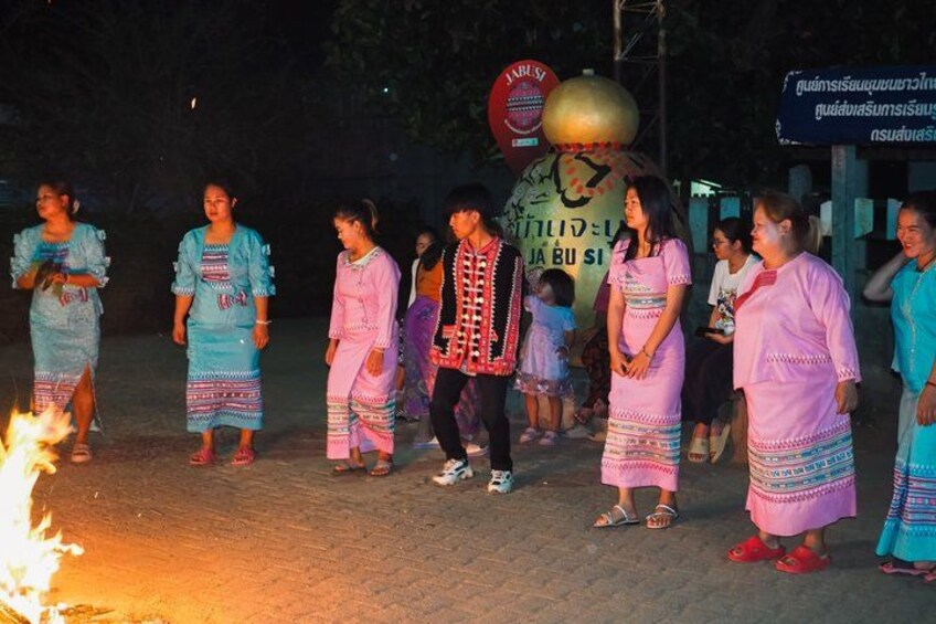 A group of people in traditional attire performing a dance. 5