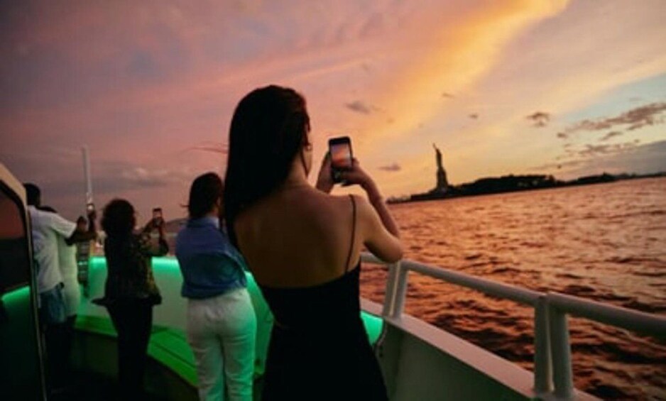 A sunset over a body of water with a silhouette of a famous monument in the distance. 2