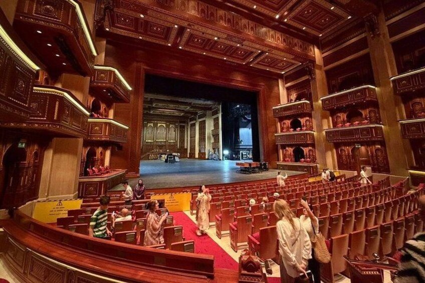 An ornate auditorium with tiered seating and a stage. 3