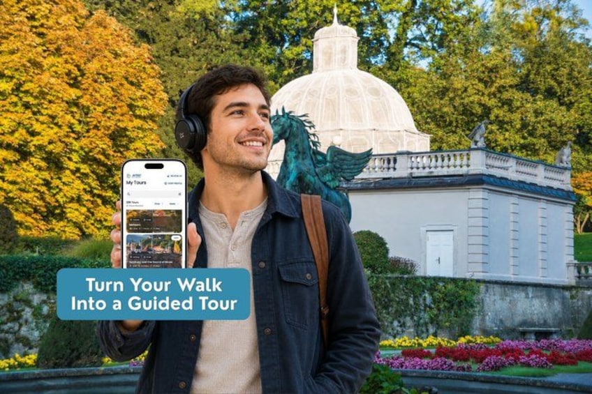 A person holding a smartphone with a tour app, standing in front of a building with a dome and a statue. 1