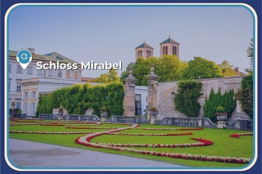 Schloss Mirabel with a garden pathway, a fountain, and a building with towers. 2