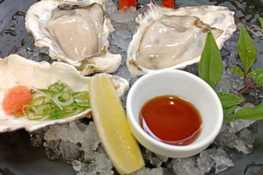 Oysters on ice with lemon wedges and two types of sauce. 3