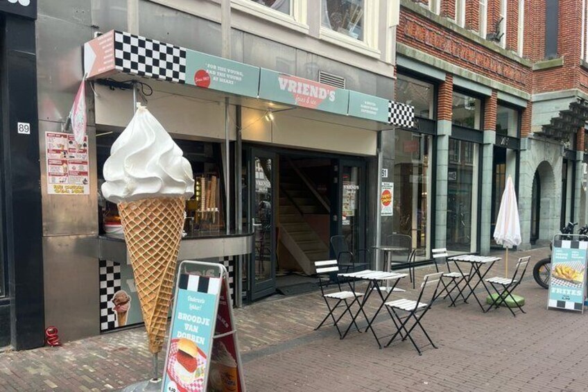 An ice cream cone outside a shop named 'Vriend's.' 5