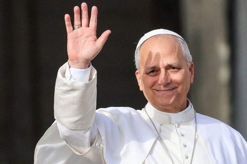 A person in a white robe with a raised hand. 1