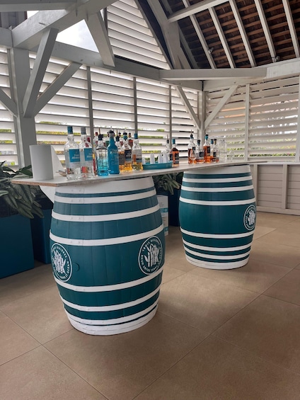 A bar area with striped barrels and bottles of liquor. 3