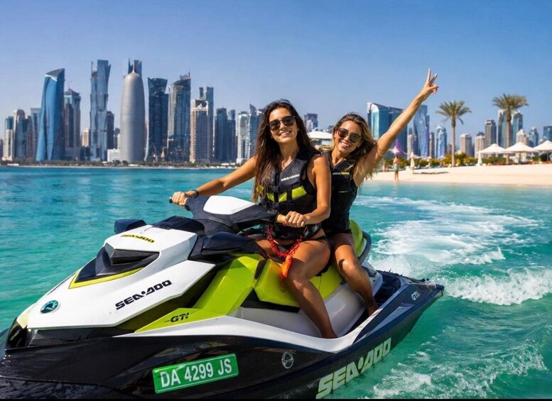 Two people on a Sea-Doo jet ski with a city skyline in the background. 3