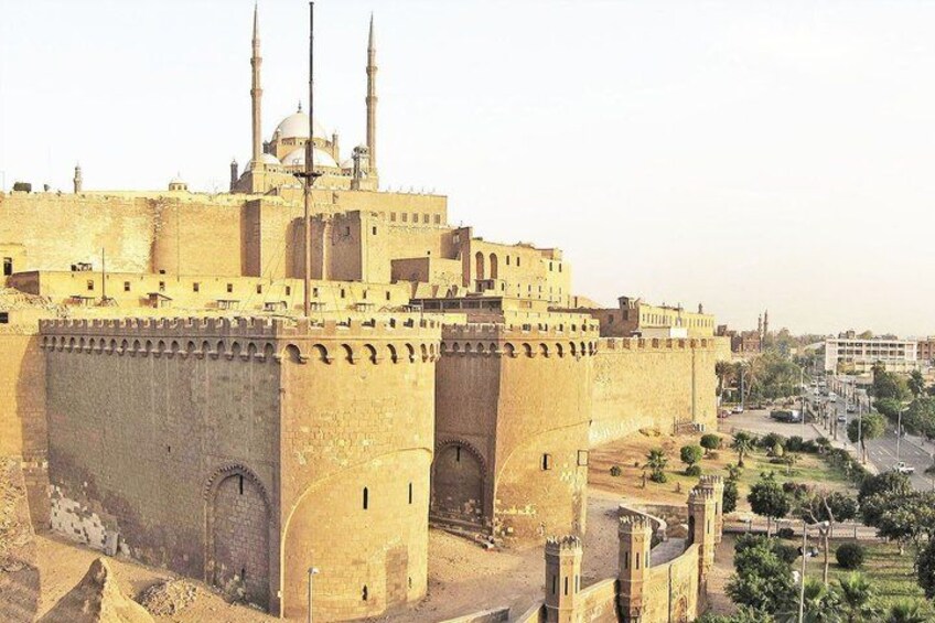 A large fortress-like structure with multiple towers and a dome, surrounded by a fortified wall. 1