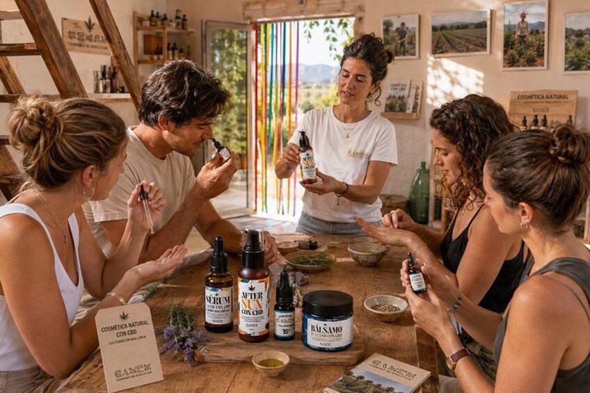 A group of people sitting around a table with various bottles and containers, likely discussing or sampling products. 4