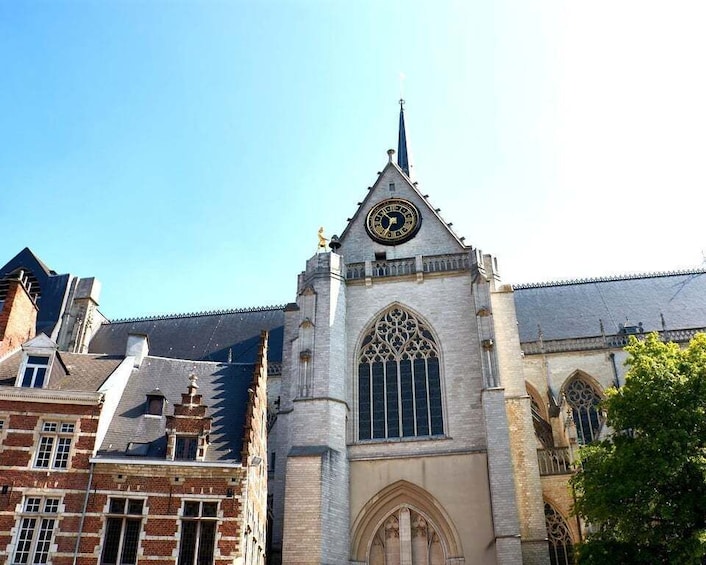 A historic church with a tall spire and a large clock. 5