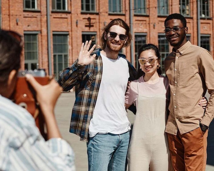 A group of people standing in front of a brick building. 4