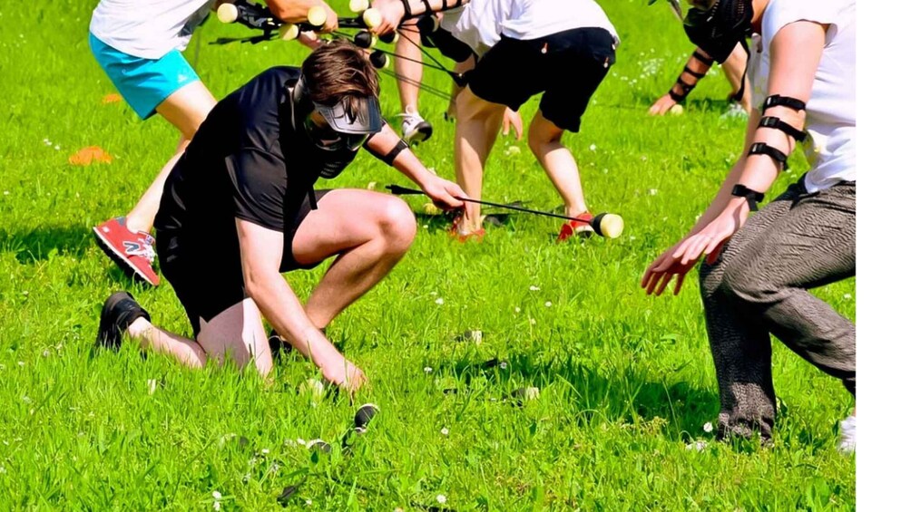 People playing a game with a ball on a grassy field. 2