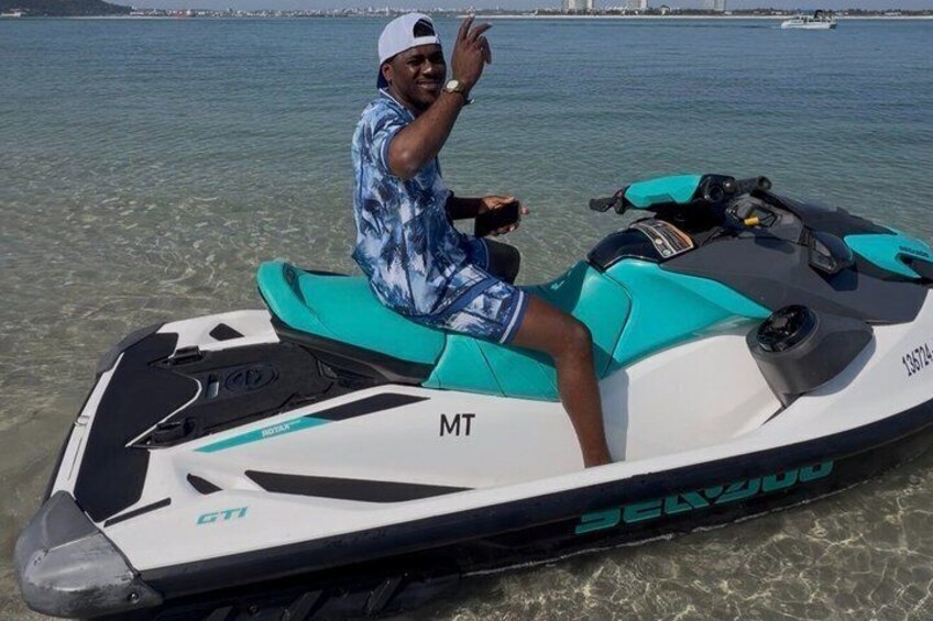 A person on a jet ski with a clear view of the water and distant shoreline. 3