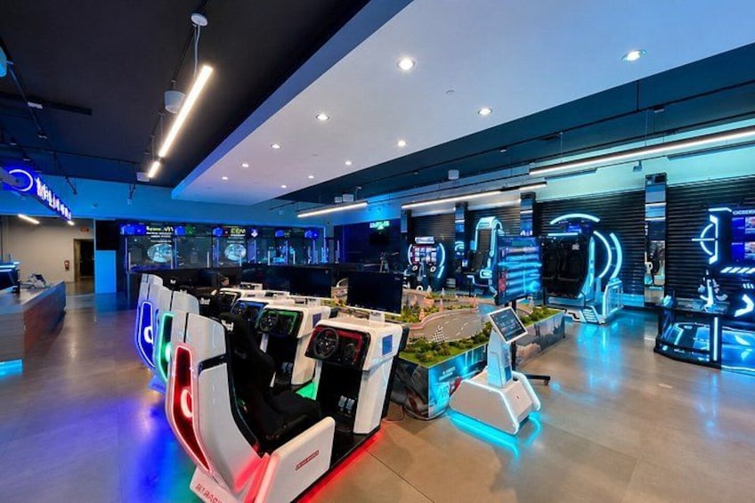 A modern gaming arcade with multiple gaming stations and neon lighting. 5