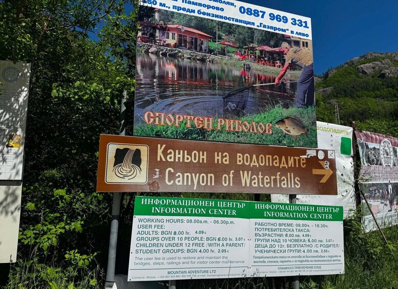 A signpost with information about a canyon of waterfalls, a mountain adventure center, and a gas station. 2