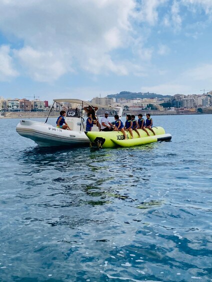 A boat with inflatable tubes and people on it. 2