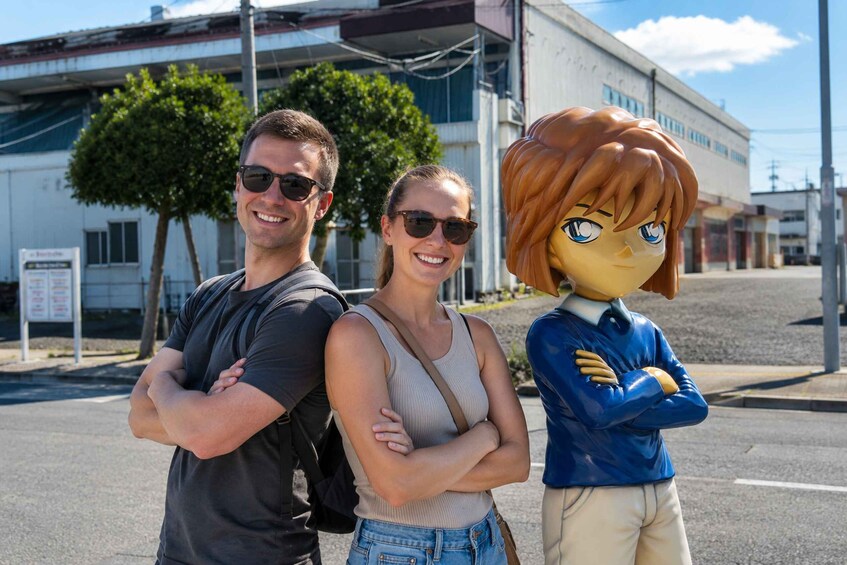A man and a woman standing with their arms crossed, a cartoon character, and a building in the background. 4