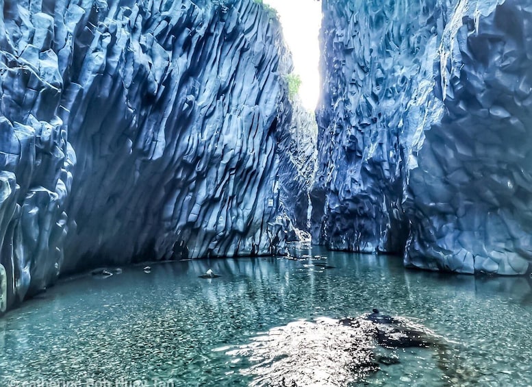 A glacier cave with water at the bottom. 3