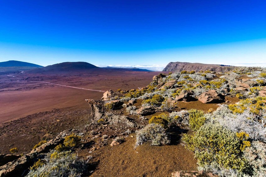 A rugged landscape with rocky outcrops and sparse vegetation. 2