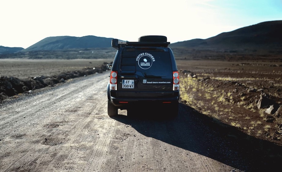 A black SUV on a dirt road with a license plate reading 'AY-398-WX'. 5