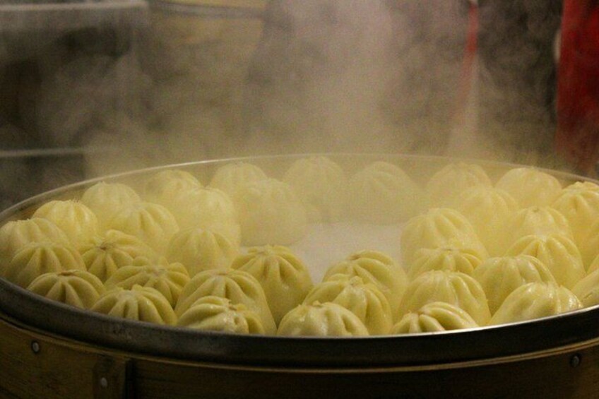 A steamer filled with dumplings. 4