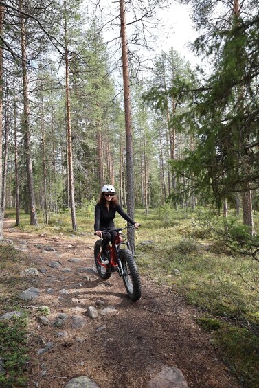 A person riding a mountain bike on a forest trail. 2