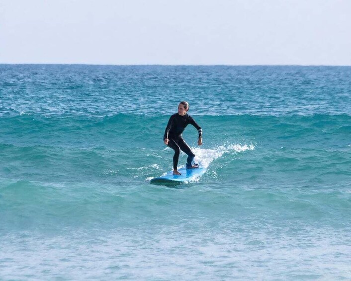 A person surfing on a wave in the ocean. 3
