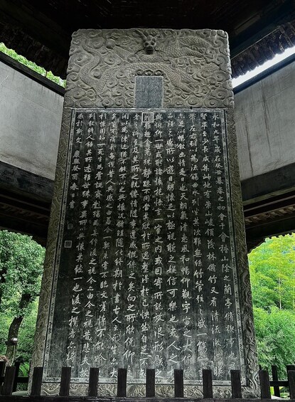 A large stone monument with intricate carvings and Chinese characters. 3