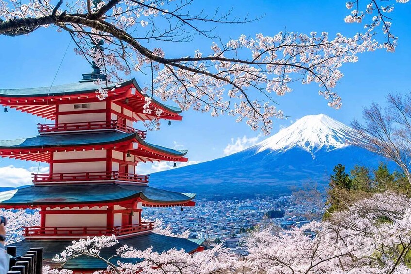 A traditional Japanese pagoda surrounded by cherry blossoms, with Mount Fuji in the background. 5